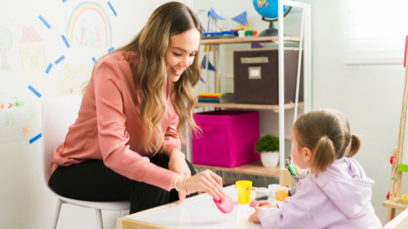 Applied Behavior Analysis therapist working with a young child in Carmel, Indiana, using play-based ABA techniques to support communication and learning skills.