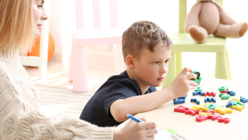 Child participating in autism testing and diagnostic evaluation with a therapist at MindWay ABA in Carmel, Indiana, focusing on developmental and behavioral assessment.