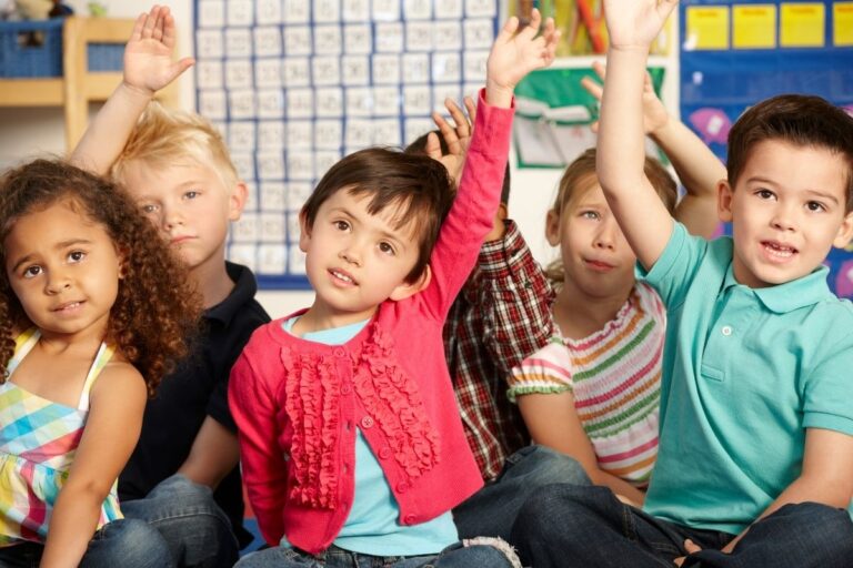 Children at MindWay ABA Therapy in Carmel raising their hands to ask Famous Questions for insurance coerage.