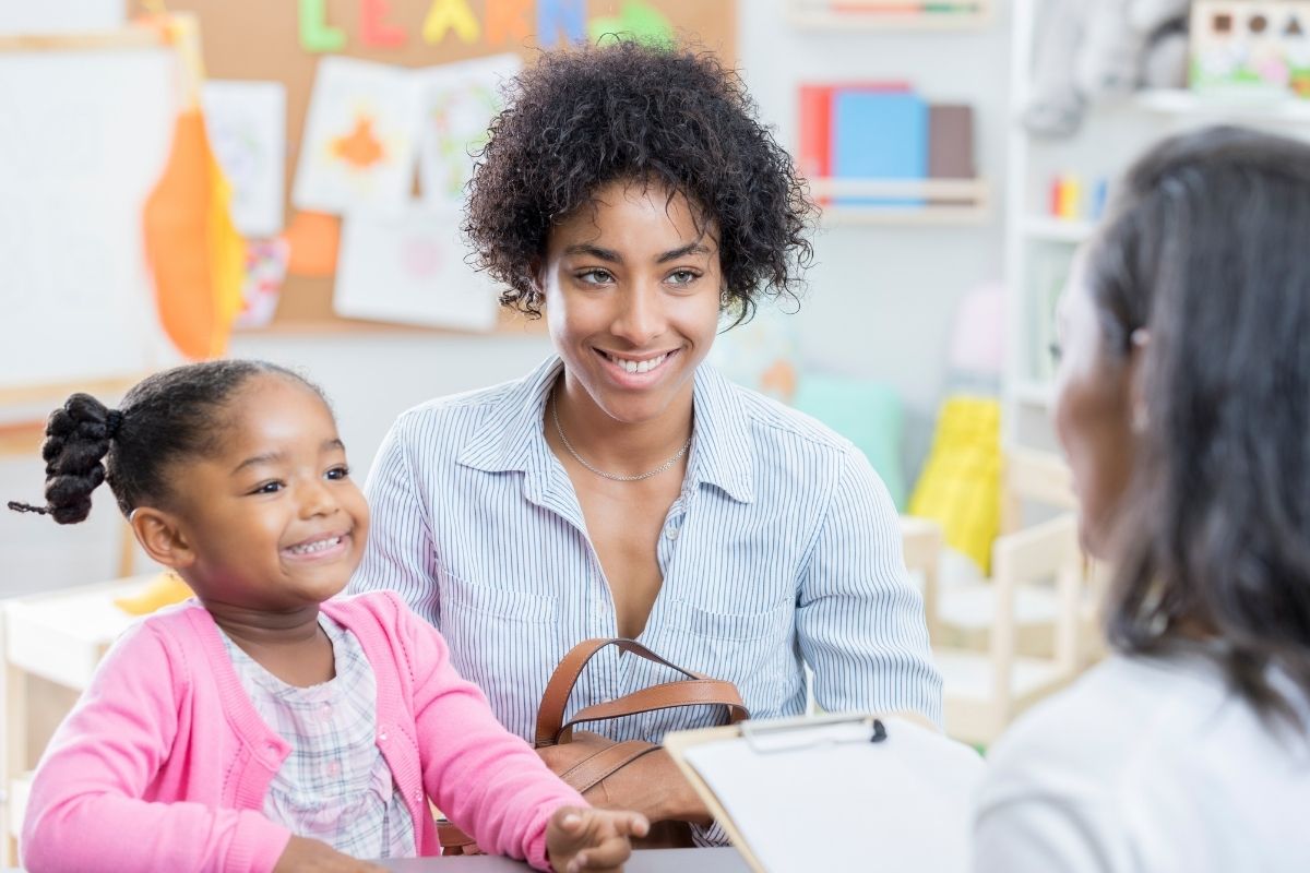 Smiling mother and child meeting with a clinician during an autism testing and diagnosis appointment at MindWay ABA in Carmel, Indiana.