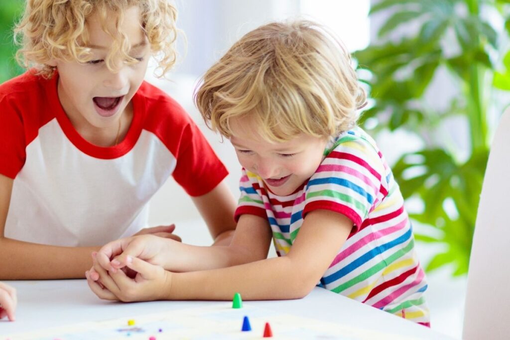 Two children playing together and strengthening communication through play-based ABA therapy.