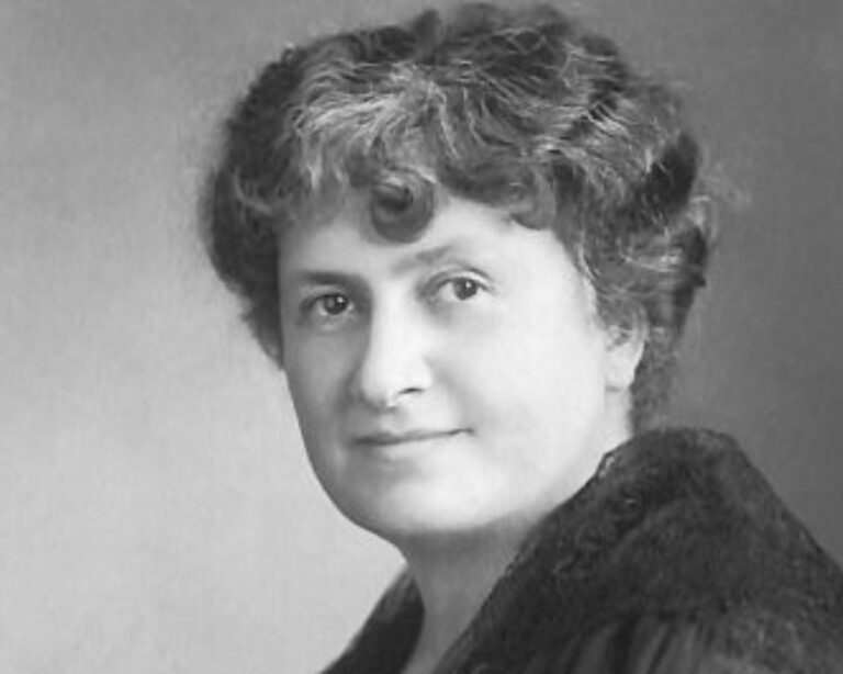 Black-and-white portrait of an early 20th-century female educator associated with Montessori learning principles, facing the camera with a calm expression.