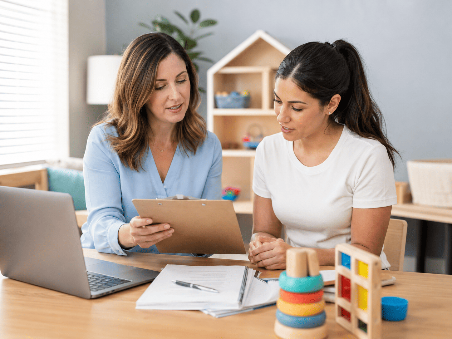 ABA clinician reviewing a treatment plan and progress information in a therapy setting