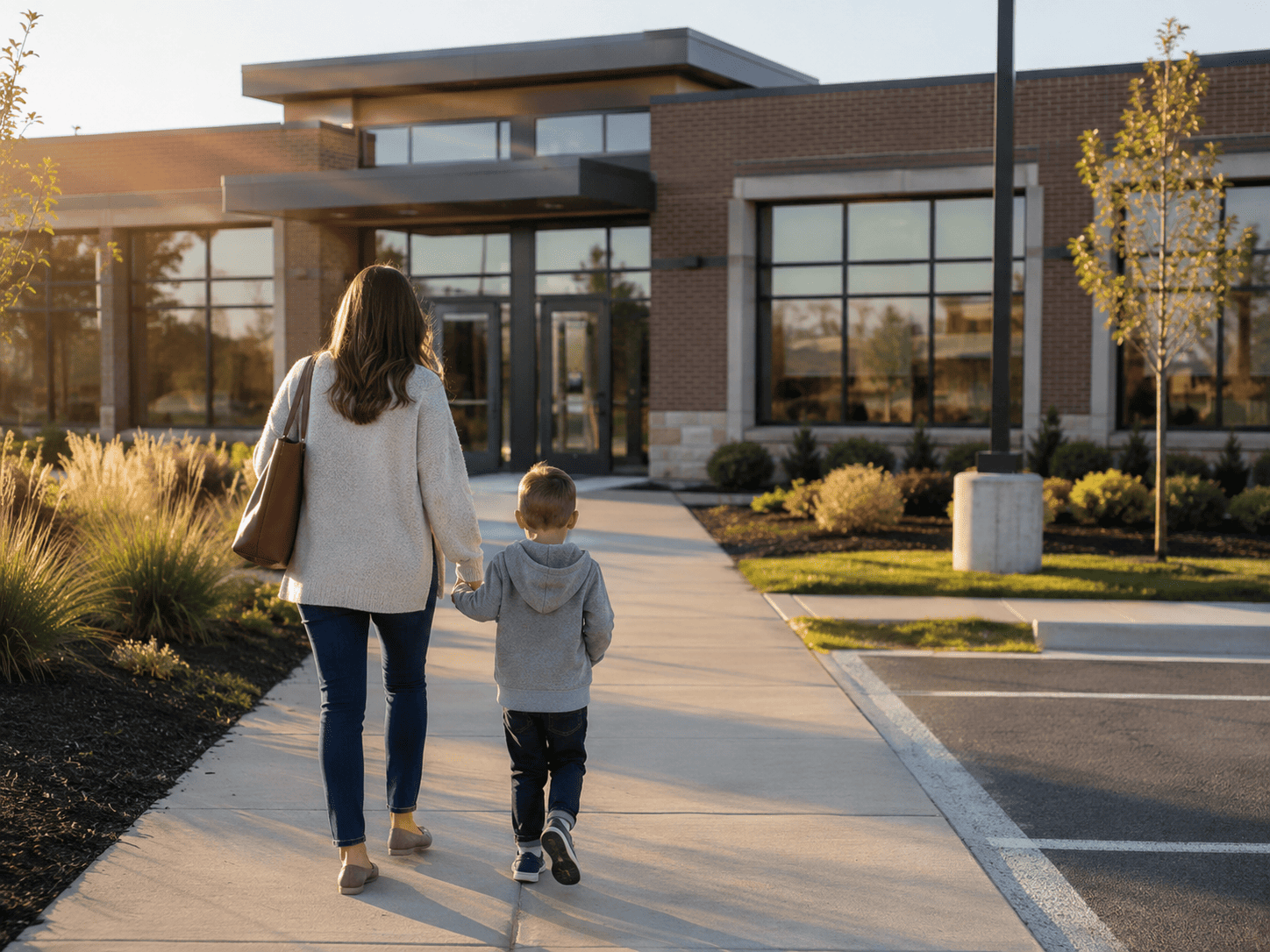 Parent and child arriving at a welcoming therapy center serving Carmel and Hamilton County